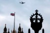 FILE - In this file photo dated Saturday, Dec. 14, 2019, a British flag waves atop of Houses of Parliament as an aircraft approaches the airport in London. After nearly five decades of economic and social integration, from the start of 2021 Britain will embark on a more-distant relationship with the European Union, and freedom of movement seems set to dramatically change for people wanting to cross the English Channel. (AP Photo/Thanassis Stavrakis, FILE)