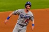 Los Angeles Dodgers' Cody Bellinger scores on a bunt by Austin Barnes during the fourth inning in Game 3 of the baseball World Series against the Tampa Bay Rays Friday, Oct. 23, 2020, in Arlington, Texas. (AP Photo/Tony Gutierrez)