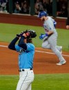 Los Angeles Dodgers first baseman Max Muncy celebrates a home run off Tampa Bay Rays starting pitcher Tyler Glasnow during the fifth inning in Game 5 of the baseball World Series Sunday, Oct. 25, 2020, in Arlington, Texas. (AP Photo/Tony Gutierrez)