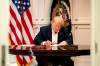 In this image released by the White House, President Donald Trump works in the Presidential Suite at Walter Reed National Military Medical Center in Bethesda, Md. Saturday, Oct. 3, 2020, after testing positive for COVID-19. (Joyce N. Boghosian/The White House via AP)