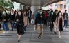 People wear protective face masks on a bridge in Hong Kong, Friday, Jan 24, 2020. China closed off a city of more than 11 million people Thursday, halting transportation and warning against public gatherings, to try to stop the spread of a deadly new virus that has sickened hundreds and spread to other cities and countries in the Lunar New Year travel rush. (AP Photo/Achmad Ibrahim)