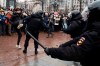 A demonstrator clashes with a police officer during a protest against the jailing of opposition leader Alexei Navalny in Pushkin square in Moscow, Russia, Saturday, Jan. 23, 2021. Russian police arrested more than 3,400 people Saturday in nationwide protests demanding the release of opposition leader Alexei Navalny, the Kremlin's most prominent foe, according to a group that counts political detentions. In Moscow, an estimated 15,000 demonstrators gathered in and around Pushkin Square in the city center, where clashes with police broke out and demonstrators were roughly dragged off by helmeted riot officers to police buses and detention trucks. Some were beaten with batons. (AP Photo/Victor Berezkin)