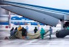 A group of medical personnel prepare to meet 80 people, accompanied by medical specialists, carried by a Russian military plane at an airport outside Tyumen, Russia, Wednesday, Feb. 5, 2020. Russia has evacuated 144 people, Russians and nationals of Belarus, Ukraine and Armenia, from the epicenter of the coronavirus outbreak in Wuhan, China, on Wednesday. All evacuees will be quarantined for two weeks in a sanatorium in the Tyumen region in western Siberia, government officials said. (AP Photo/Maxim Slutsky)