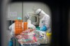 This Saturday, Feb. 22, 2020, photo released by Xinhua News Agency, shows medical workers in protective suits at a coronavirus detection lab in Wuhan in central China's Hubei Province. The fresh national figures for the disease that emerged in China in December came as the number of viral infections soared mostly in and around the southeastern city of Daegu, where they were linked to a local church and a hospital. (Cheng Min/Xinhua via AP)