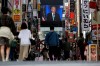 A screen shows a broadcast of President-elect Joe Biden speaking Sunday, Nov. 8, 2020 at the Shinjuku shopping district in Tokyo. (AP Photo/Kiichiro Sato)