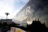 The Duomo gothic cathedral is reflected in a bus of fashion buyers in Milan, Italy, Sunday, Feb. 23, 2020. A dozen Italian towns saw daily life disrupted after the deaths of two people infected with the virus from China and a pair of case clusters without direct links to the outbreak abroad. A rapid spike in infections prompted authorities in the northern Lombardy and Veneto regions to close schools, businesses and restaurants and to cancel sporting events and Masses. (AP Photo/Luca Bruno)