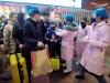 Medical workers use an infrared thermometer to check travelers at a train station in Nanchang in southern China's Jiangxi Province, Wednesday, Jan. 22, 2020. Chinese health authorities urged people in the city of Wuhan to avoid crowds and public gatherings, after warning that a new viral illness that has infected more than 400 people and killed at least nine could spread further. (Chinatopix via AP)