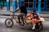 A man transports children on his tricycle, in Havana, Cuba, Friday, Jan 8, 2021, amid the new coronavirus pandemic. (AP Photo/Ramon Espinosa)