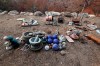 Objects found in the rubble of the home of Justin Kam and Helena Wong are laid out after a fire destroyed their house at Balmoral, Australia, Tuesday, Jan. 7, 2020. Kam and Wong built their home with quarter-inch thick reinforced glass, steel framing and rock surrounds to protect them from Australia's notorious wildfires. But as they stayed home with their son and battled flames that soared as high as a 15-story building, they realised they were in mortal danger. (AP Photo/Rick Rycroft)