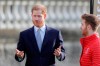 Britain's Prince Harry gestures next to Rugby League World Cup 2021 (RLWC2021) ambassador James Simpson in the gardens at Buckingham Palace in London, Thursday, Jan. 16, 2020. Prince Harry, the Duke of Sussex will host the Rugby League World Cup 2021 draw at Buckingham Palace, prior to the draw, The Duke met with representatives from all 21 nations taking part in the tournament, as well as watching children from a local school play rugby league in the Buckingham Palace gardens. (AP Photo/Kirsty Wigglesworth)