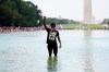 A man stands in the Reflecting Pool as people attend the March on Washington, Friday Aug. 28, 2020, in Washington, on the 57th anniversary of the Rev. Martin Luther King Jr.'s 