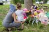 NICOLE OSBORNE - AFP via GETTY IMAGES
Families pay their respects at a makeshift memorial near the site where four members of a Muslim family were killed in London, Ont.