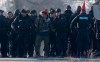 Ontario Provincial Police officers make arrests at a rail blockade in Tyendinaga Mohawk Territory, near Belleville, Ont., on Monday Feb. 24, 2020. A police operation that saw officers descend on a rail blockade on Tyendinaga Mohawk Territory in central Ontario and arrest several protesters has cleared the way for train service to resume. THE CANADIAN PRESS/Adrian Wyld