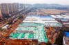 The Huoshenshan temporary field hospital under construction is seen as it nears completion in Wuhan in central China's Hubei Province, Sunday, Feb. 2, 2020. The Philippines on Sunday reported the first death from a new virus outside of China, where authorities delayed the opening of schools in the worst-hit province and tightened quarantine measures in a city that allow only one family member to venture out to buy supplies. (Chinatopix via AP)