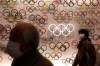 Two people wear masks as they visit the newly opened Japan Olympic Museum located near the New National Stadium, Sunday, Feb. 23, 2020, in Tokyo. (AP Photo/Jae C. Hong)