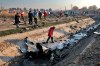 Rescue workers inspect the scene where a Ukrainian plane crashed in Shahedshahr, southwest of the capital Tehran, Iran, Wednesday, Jan. 8, 2020. A Ukrainian airplane with more than 170 people crashed on Wednesday shortly after takeoff from Tehran's main airport, killing all onboard. (AP Photo/Ebrahim Noroozi)