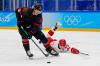 Matt Slocum - AP
Canada's Adam Tambellini avoids pressure from China's Tyler Schultz during their men's playoff qualification round match Tuesday in Beijing.