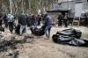 GENYA SAVILOV - AFP via GETTY IMAGES
City workers carry body bags with six partially burnt bodies found in the town of Bucha on April 5, 2022, as Ukrainian officials say over 400 civilian bodies have been recovered from the wider Kyiv region, many of which were buried in mass graves.