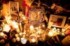 Photographs are left among candles at a memorial during a vigil in Toronto on Thursday, January 9, 2020, to remember the victims of the Iranian air crash. THE CANADIAN PRESS/Chris Young