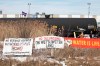 Banners hang on a fence as protesters stage a blockade of the rail line at Macmillan Yard in Toronto, Saturday, Feb. 15, 2020. The protest is in solidarity with the Wet'suwet'en hereditary chiefs opposed to the LNG pipeline in northern British Columbia. THE CANADIAN PRESS/Chris Young