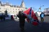 DAVE CHAN - AFP via GETTY IMAGES
A supporter carries a U.S. Confederate flag in front of Parliament on Saturday.