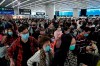 Passengers wear protective face masks at the departure hall of the high speed train station in Hong Kong, Thursday, Jan. 23, 2020. China closed off a city of more than 11 million people Thursday, halting transportation and warning against public gatherings, to try to stop the spread of a deadly new virus that has sickened hundreds and spread to other cities and countries in the Lunar New Year travel rush. (AP Photo/Kin Cheung)