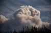 DARRYL DYCK - The Canadian Press
A helicopter carrying a water bucket flies past a fire cloud, produced by the Lytton Creek wildfire burning in the mountains above Lytton, B.C., on Aug. 15, 2021.