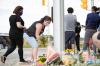 NICOLE OSBORNE - AFP via GETTY IMAGES
People pay their respects at the scene where a man struck and killed four members of a Muslim family in London, Ont.