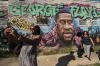 BRETT COOMER - HOUSTON CHRONICLE VIA AP
Laynette Jacob takes a photo in front of a George Floyd mural with her friends in Minneapolis after learning of the guilty verdict on all counts in the murder trial of former Minneapolis police Officer Derek Chauvin in the death of Floyd.