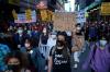 Seth Wenig - The Associated Press
A group of protesters walk through the streets after the verdict in the trial of Derek Chauvin was announced in New York on Tuesday.