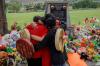 COLE BURSTON - AFP via GETTY IMAGES
People from the Mosakahiken Cree Nation hug in front of a makeshift memorial at the former Kamloops Indian Residential School to honor the 215 children whose remains were discovered buried near the facility.