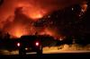 DARRYL DYCK - THE CANADIAN PRESS File
A motorist watches from a pullout on the Trans-Canada Highway as a wildfire burns on the side of a mountain in Lytton, B.C., Thursday, July 1, 2021. Aside from the physical threat of injury from fire and floods, there are risks to mental health from the displacement caused by these events, one expert told the Star.