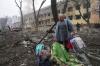 Evgeniy Maloletka - AP
A woman walks outside a maternity hospital that was damaged by shelling in Mariupol, Ukraine.