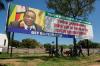 Tafadzwa Ufumeli - GETTY IMAGES
People seek shade under a billboard of Zimbabwe's president that encourages citizens to get vaccinated on Nov. 30, 2021 in Harare, Zimbabwe. Zimbabwe is among the southern African countries facing travel bans after COVID-19’s Omicron variant was first reported in neighbouring South Africa.