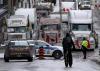 Adrian Wyld - THE CANADIAN PRESS
A cyclist rides towards a police barricade where trucks are lined up near Parliament Hill on Feb. 2, 2022 in Ottawa.