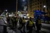 ED JONES - AFP via GETTY IMAGES
Police officers walk past protesting truck drivers on Parliament Hill in Ottawa on Feb. 13, 2022. The police have the capacity to enforce the law, if they choose to, Althia Raj writes.