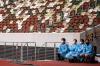 PHILIP FONG - AFP via GETTY IMAGES
This file photo taken on May 11, 2021 shows staff members in protective clothing and masks standing by next to empty seats during a para-athletics test event for the 2020 Tokyo Olympics at the National Stadium in Tokyo. - Tokyo's Olympics will be like no other Games, with the spectre of coronavirus hanging over every part of the event, and organisers determined to prevent an outbreak.
