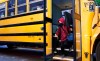 A student walks off the bus at the Bancroft Elementary School in Montreal, on Monday, August 31, 2020. THE CANADIAN PRESS/Paul Chiasson