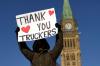 Adrian Wyld - THE CANADIAN PRESS
A protester participating in the cross-country convoy protest holds a sign on Parliament Hill in Ottawa on Sat., Jan. 29, 2022. The politics of the protest have become an increasingly tricky topic to navigate in the workplace, forcing employers to balance their staff’s freedom of expression with corporate reputational harm.
