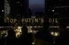 VALERIA MONGELLI - AFP via GETTY IMAGES
Demonstrators and Ukrainian activists stand in front of signs reading “Stop Putin's oil” during a vigil for Ukraine near the European Union headquarters in Brussels on March 22, 2022.