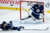 CP
Connor Hellebuyck and Tucker Poolman can't stop the shot from Ottawa's Tim Stutzle as he scores his second goal of the game during the third period. (John Woods / The Canadian Press)