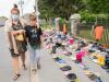 Graham Hughes - THE CANADIAN PRESS
Lynn Karonhia-Beauvais and grandson Jamieson Kane put down tobacco as a tribute to victims of the residential school system as they walk next to children's shoes outside St. Francis Xavier Church in Kahnawake, Que.