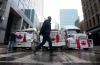 Adrian Wyld - THE CANADIAN PRESS
A person walks past trucks parked on a street in downtown Ottawa on Wednesday.