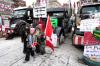 Justin Tang - THE CANADIAN PRESS
Children pose with a protester in front of semi-trailer trucks on Wellington Street, Ottawa. Who will be caught in the Emergencies Act’s account-freezing law is not yet clear.