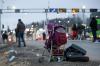 Visar Kryeziu - AP
A suitcase and stroller are left beside the road as Ukrainian refugees flee Russian invasion at a border crossing in Medyka, Poland, on Wednesday.