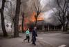 AFP Contributor#AFP - AFP via GETTY IMAGES
Residents run near a burning house following a shelling Severodonetsk, Donbass region, on April 6, 2022.