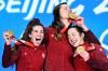 WANG ZHAO - AFP via GETTY IMAGES
Canada's Ivanie Blondin, left to right, Isabelle Weidemann and Valerie Maltais celebrate on the podium after winning gold in the women's long-track speedskating team pursuit on Tuesday in Beijing.