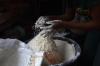 PIUS UTOMI EKPEI - AFP via GETTY IMAGES
A vendor measures wheat flour in a cup for retail at a market in Ibafo, Ogun State, southwest Nigeria, on March 14, 2022. From Nigerian airlines to Malawi bakers, African countries are feeling the pain of Ukraine's crisis as supply disruptions hike inflation and oil prices push up fuel costs. Global oil prices touched ten-year highs of more than $100 a barrel soon after Russia invaded Ukraine, doubling diesel prices for African countries like Nigeria. Ukraine and Russia are both major suppliers of wheat and grains to Africa and Western sanctions and disruptions are already hiking costs across the continent.