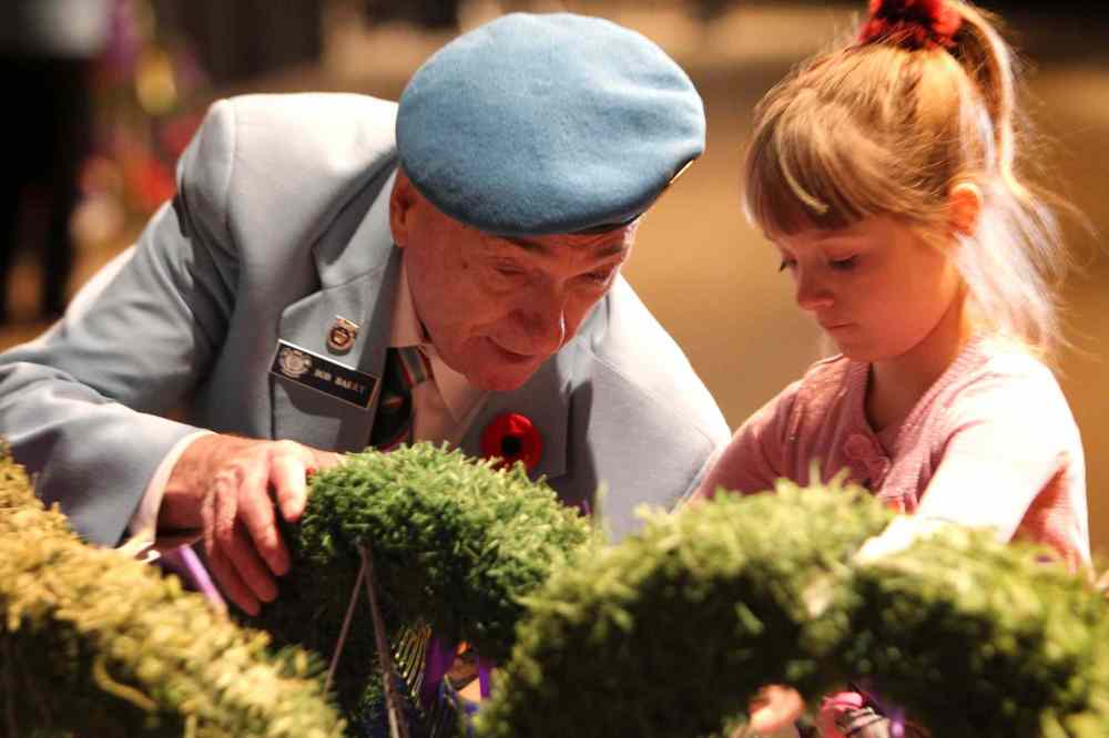 RUTH BONNEVILLE / WINNIPEG FREE PRESS

Annabelle Barry (7) lays a wreath with her great-grandfather, Capt  Bob Barry Capt. at  the annual Remembrance Day ceremony Saturday.