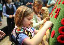Sparks Clare Miltika pins a poppy on the cenotaph.